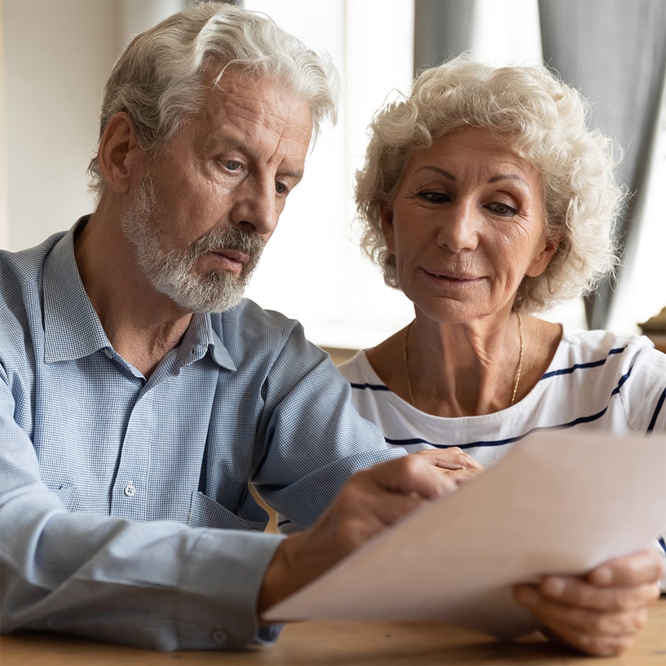 Mature couple reviewing paperwork.
