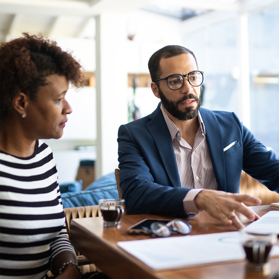 Man and woman meeting with advisor.