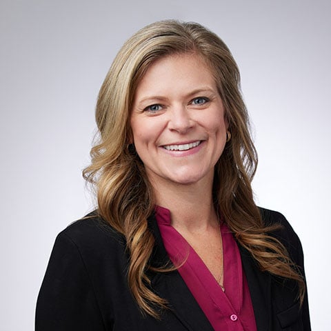 Heather Osborn professional headshot with grey background.