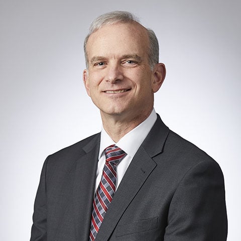 Tim Steffen professional headshot with grey background.