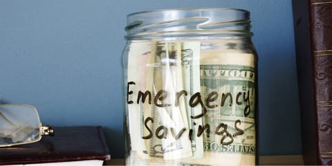 Jar containing money and labeled - Emergency Savings