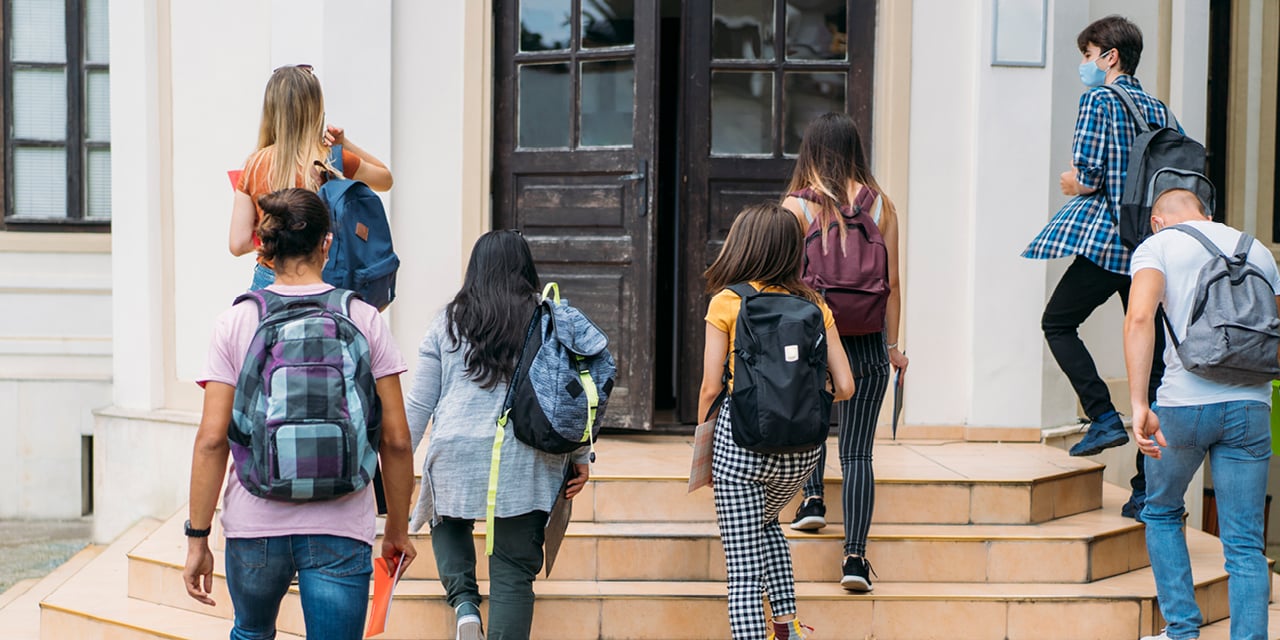 High school students walking into school