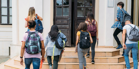 High school students walking into school