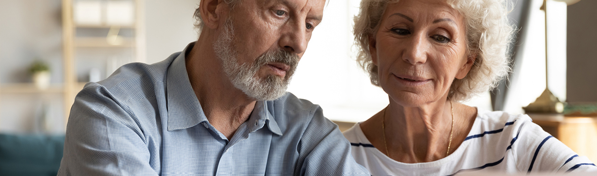 Mature couple reviewing paperwork.