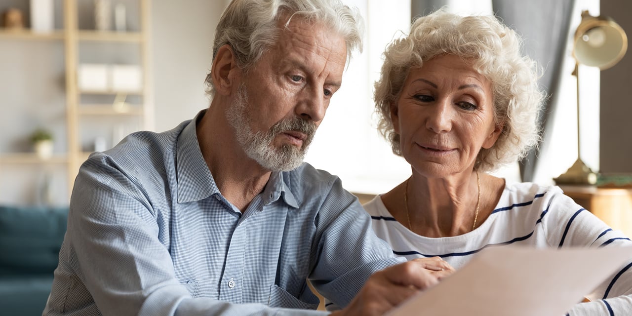 Mature couple reviewing paperwork.