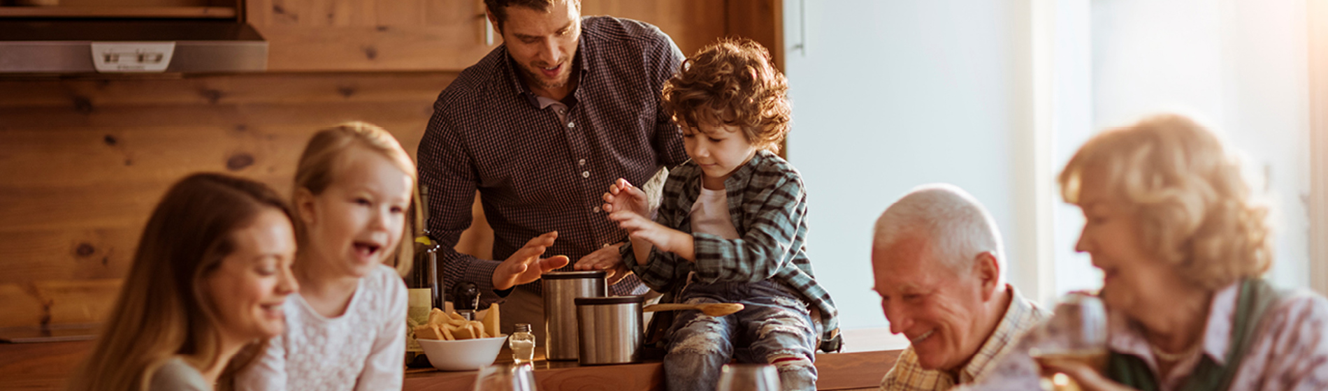 Multigenerational family together at a dining room table.