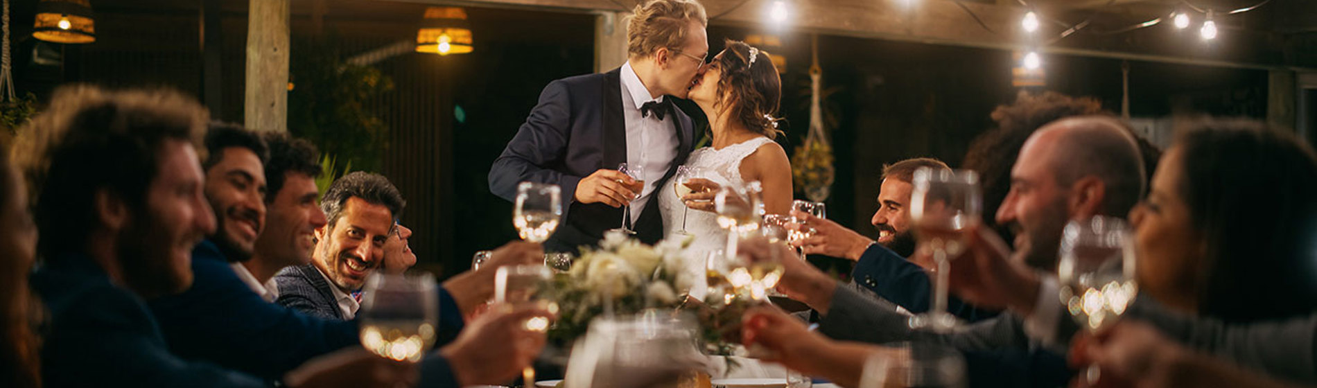 Wedding couple kissing during a toast