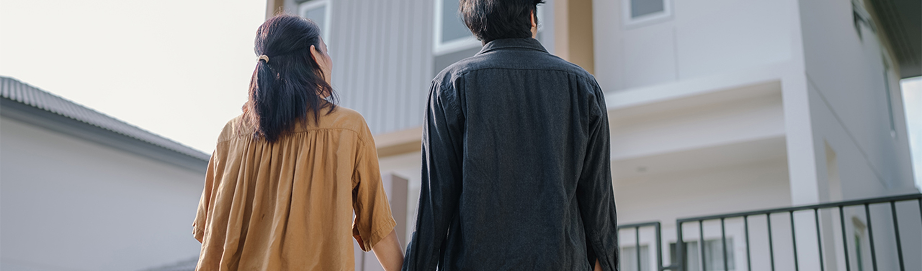 Woman and man looking at a house.