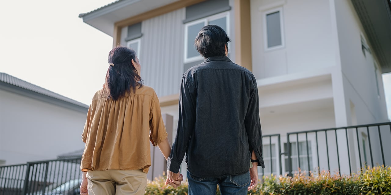 Woman and man looking at a house.