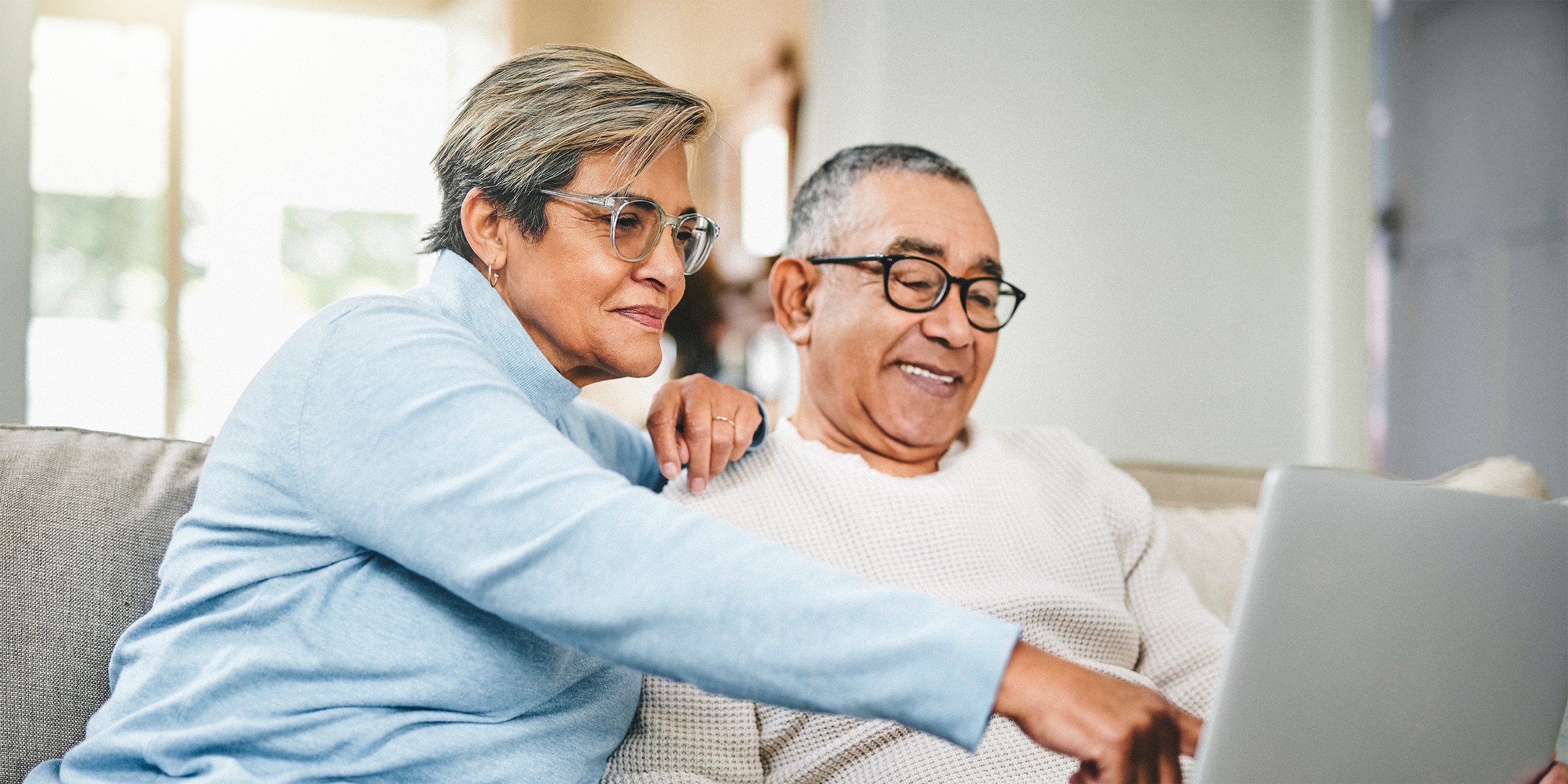 Retired couple looking at a computer screen