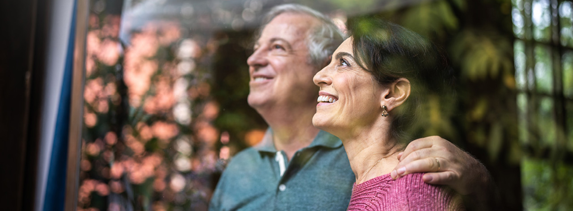 a retired couple looking out a window