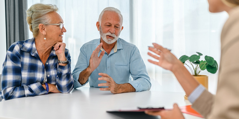 Mature couple meeting with advisor.