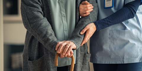 Nurse helping an elderly patient.