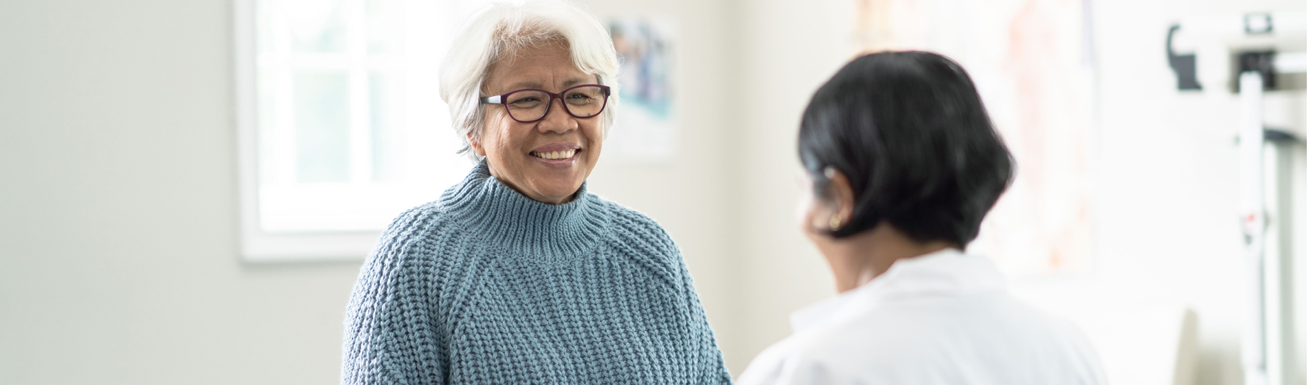 Older woman talking to a doctor.
