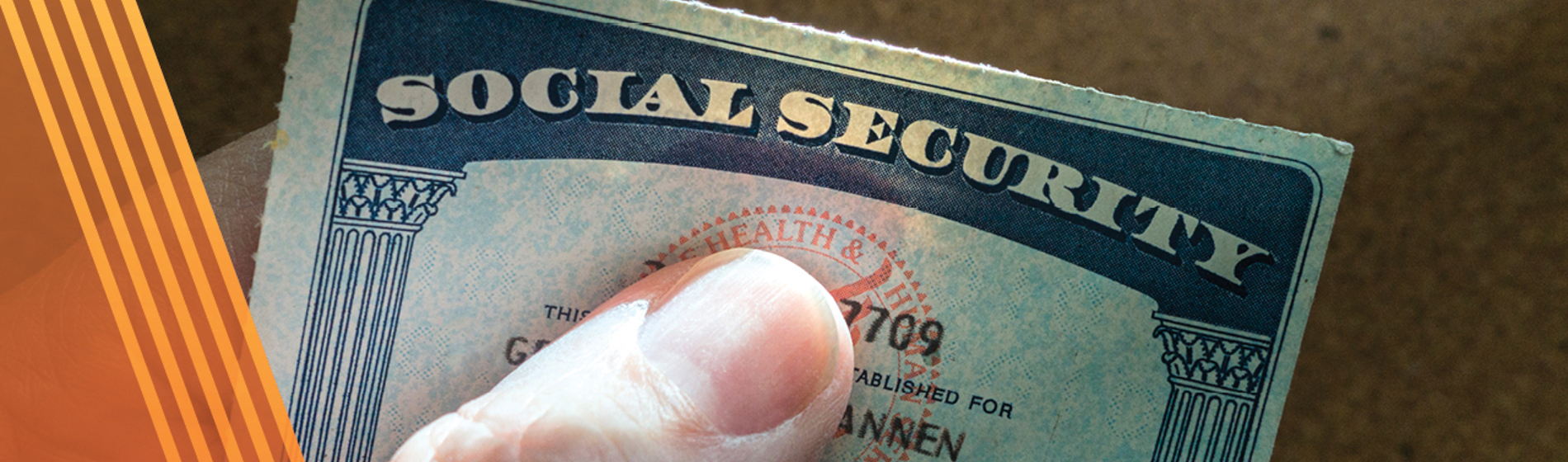 Hand holding a social security card.