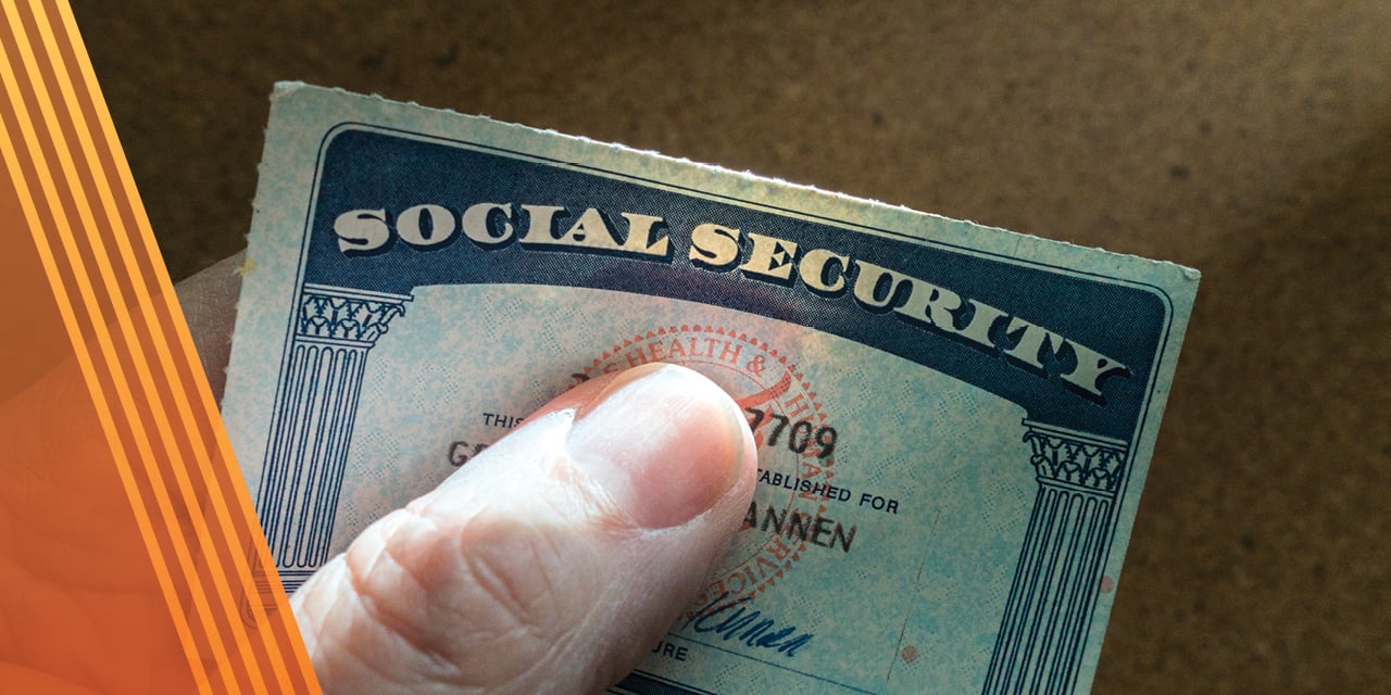 Hand holding a social security card.