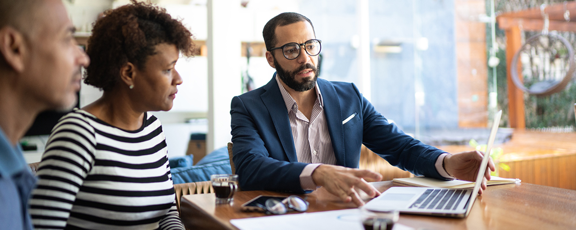 Couple meeting with an advisor at home.