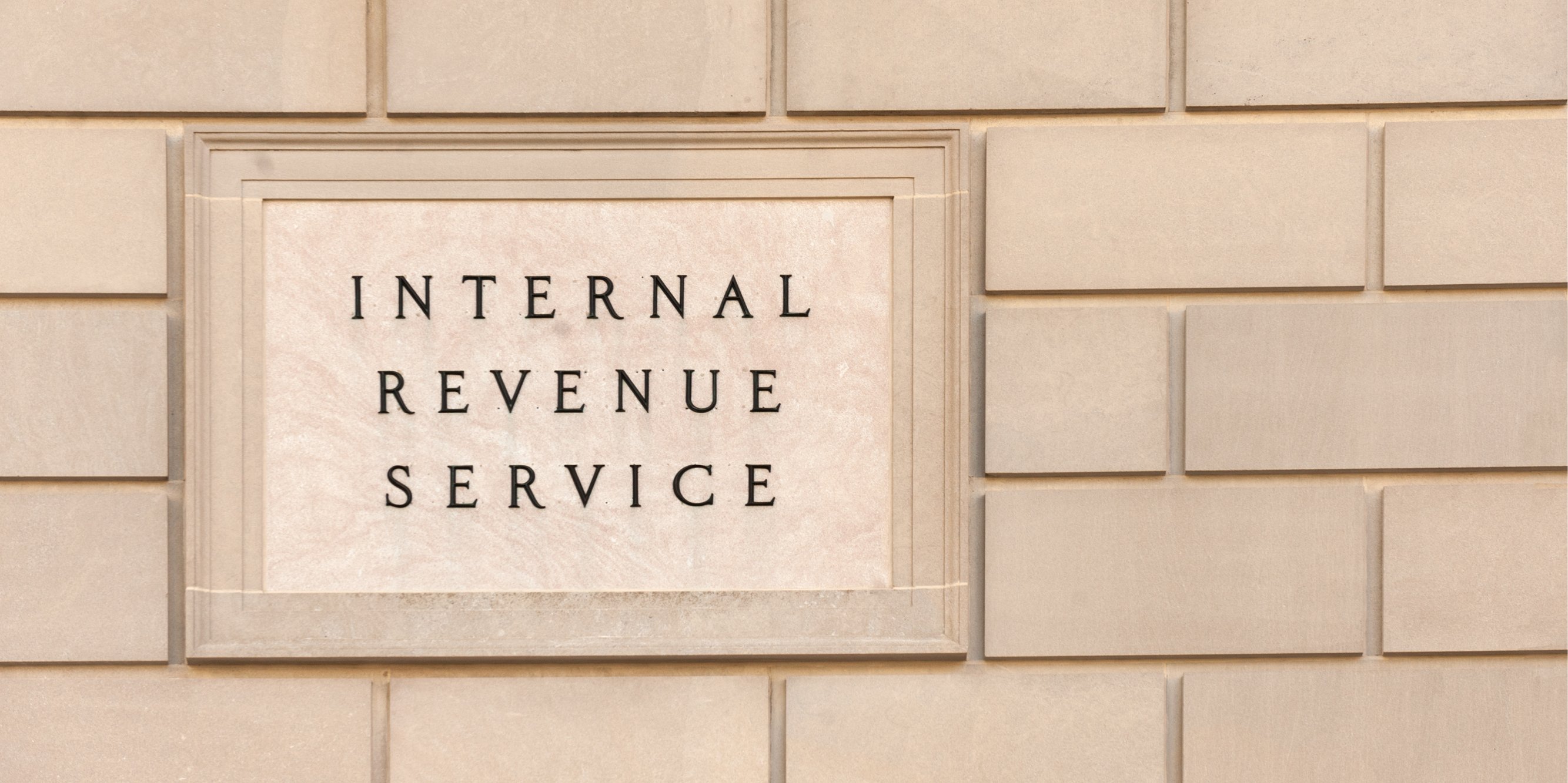 Brick wall with a sign containing the words Internal Revenue Service