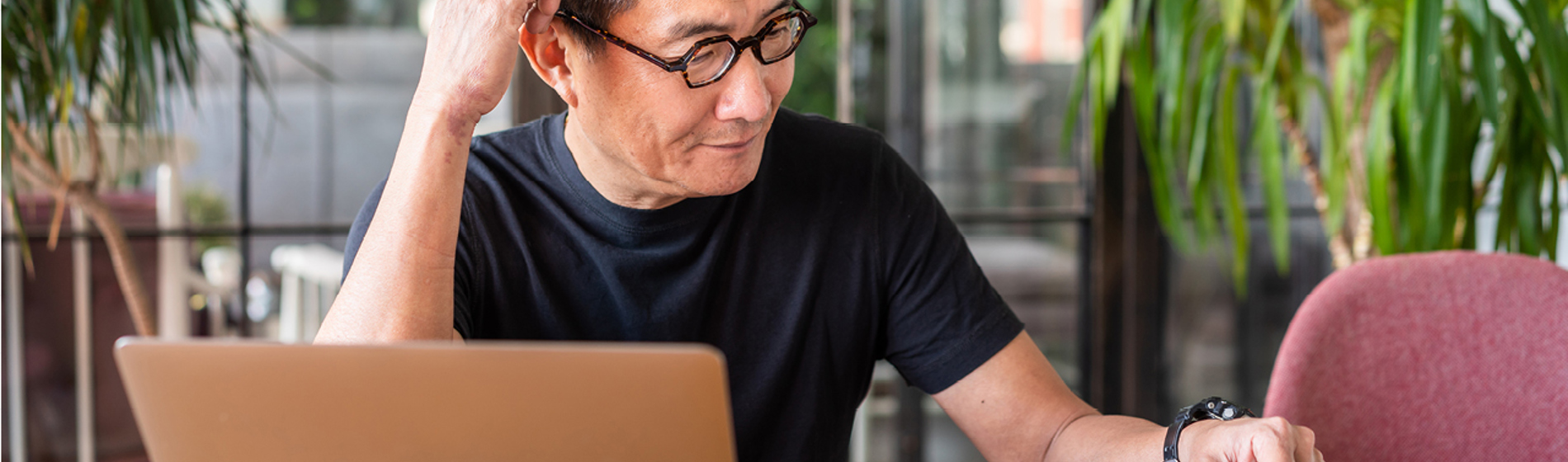 Man sitting at a desk looking at paperwork.