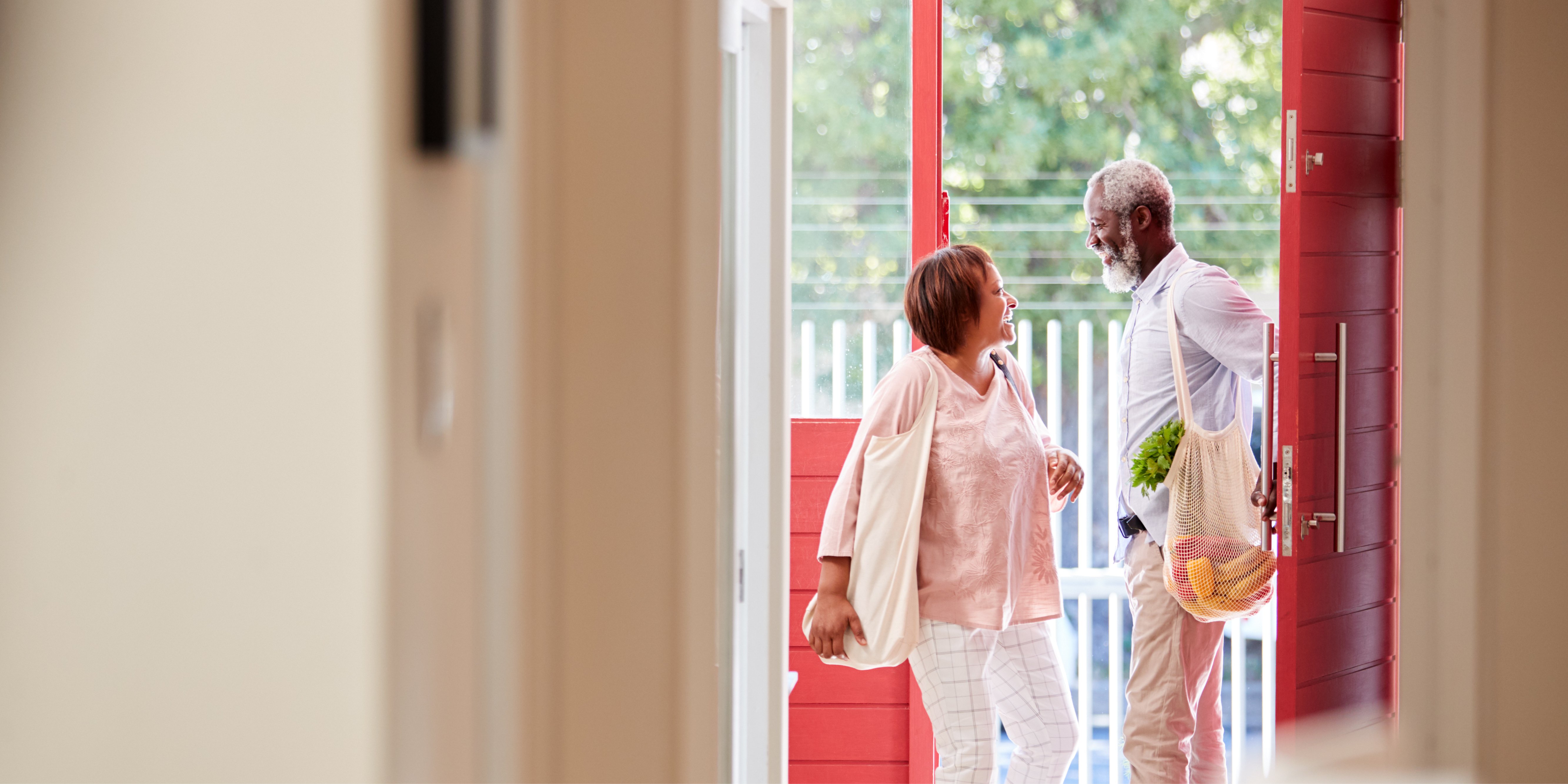 Mature couple entering the backdoor of a home