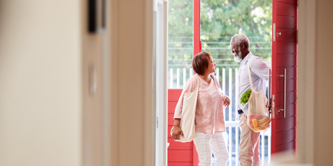 Mature couple entering the backdoor of a home