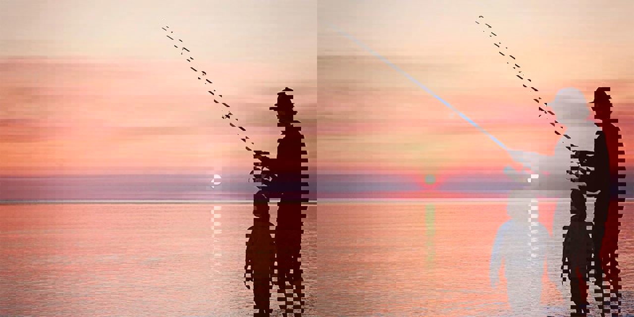 Parent and child fishing at sunset.