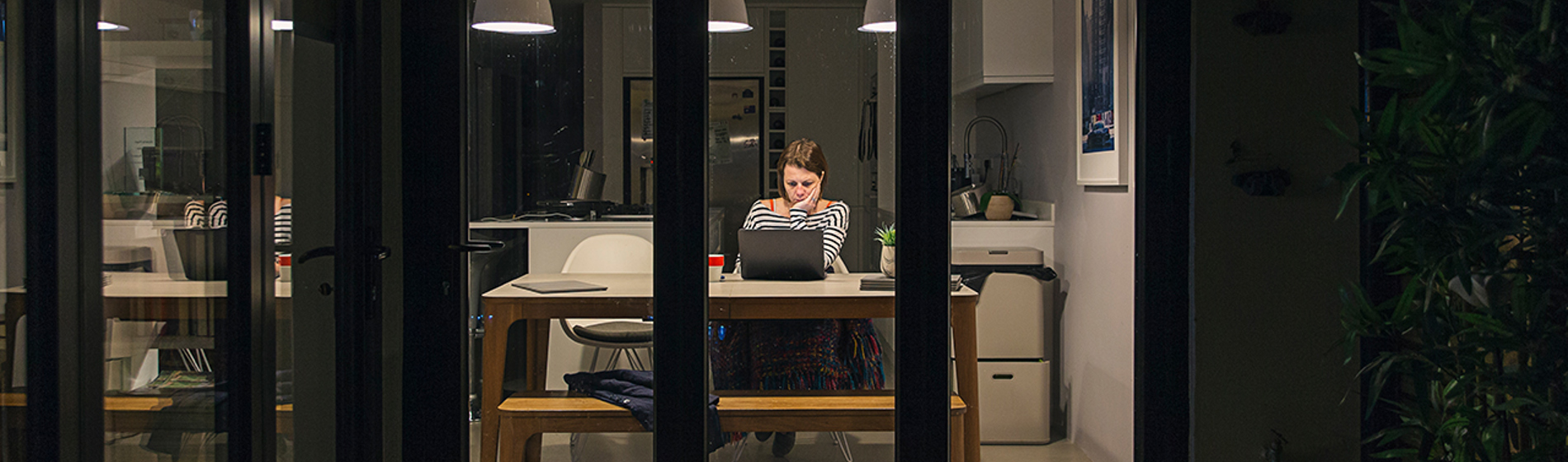 Women working as a desk in her home.