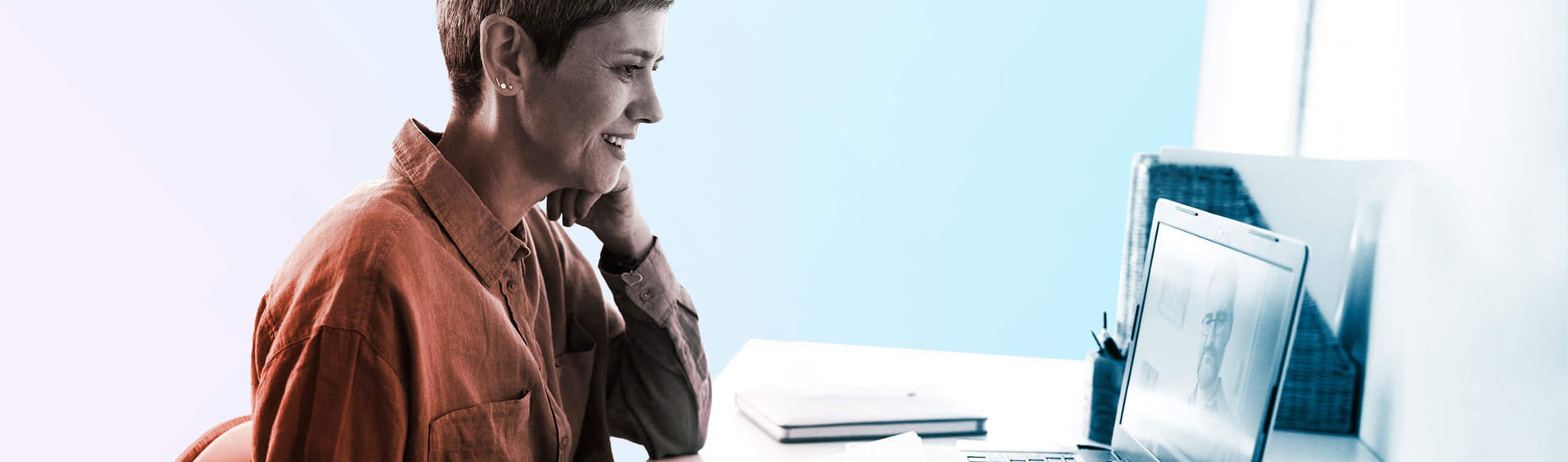 Woman following online courses on her laptop at home