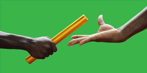 Two men passing golden baton