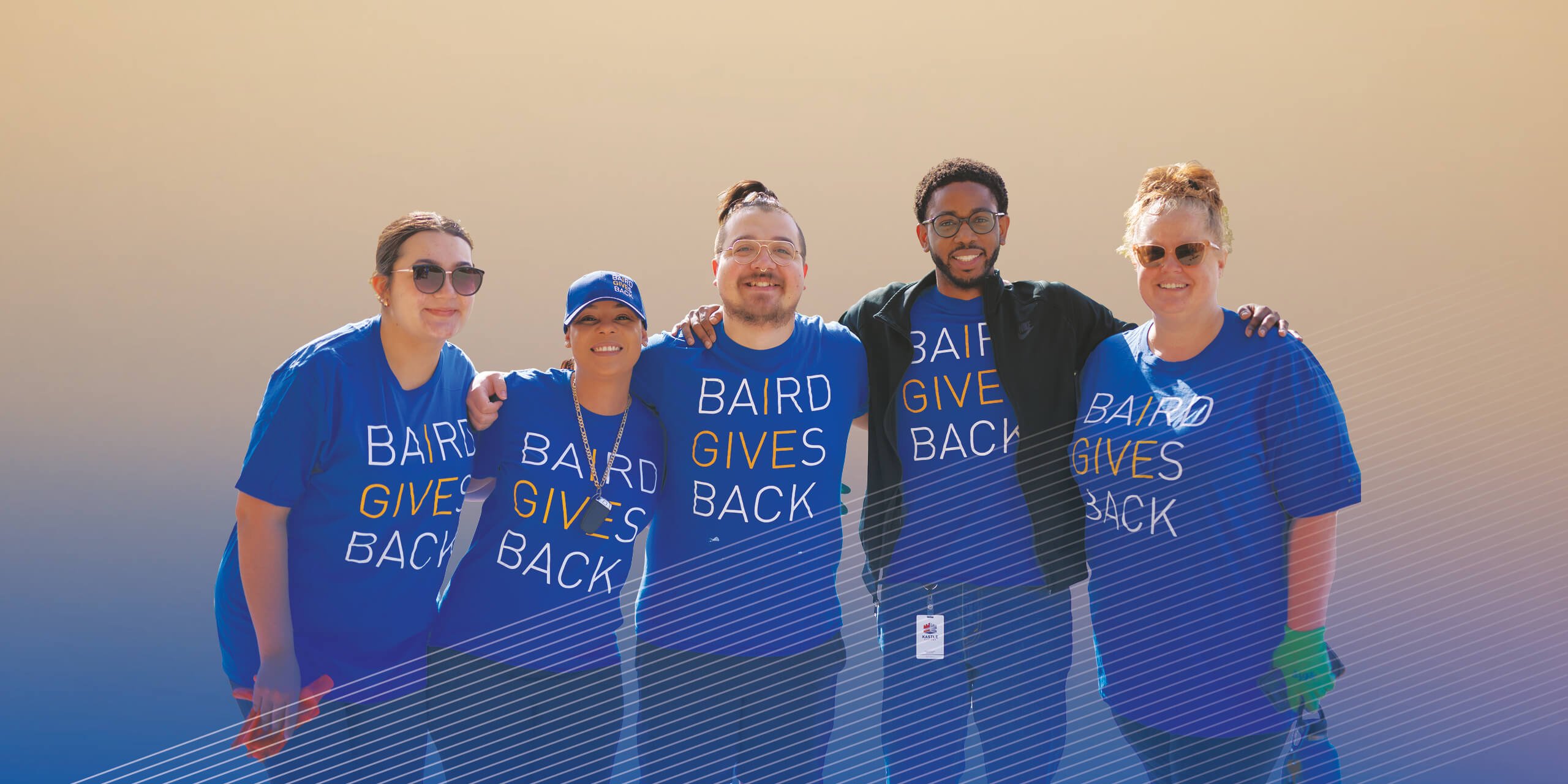 Baird associates posing for photo while volunteering