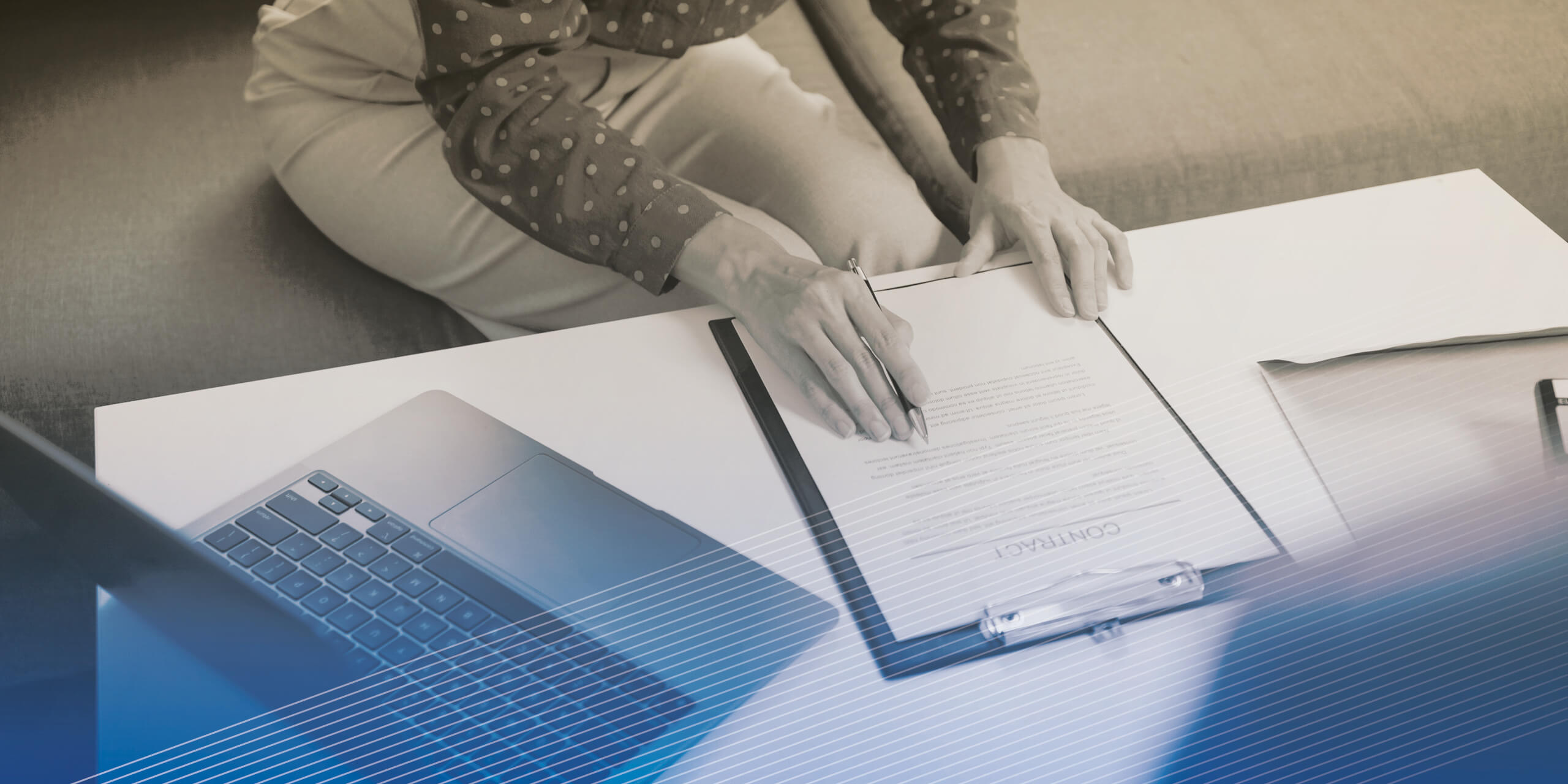 Close up of businesswoman signing contract on sofa in living room at home