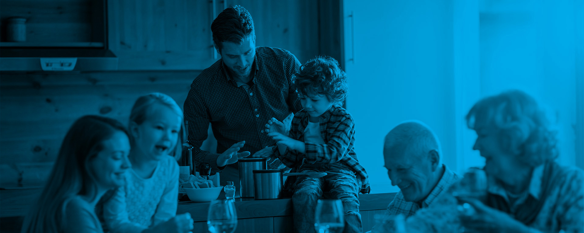 Multi-generational family preparing meal