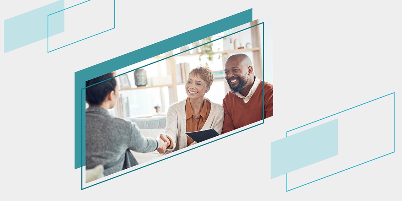 Teal parallelograms framing an image of a couple meeting with their financial advisor
