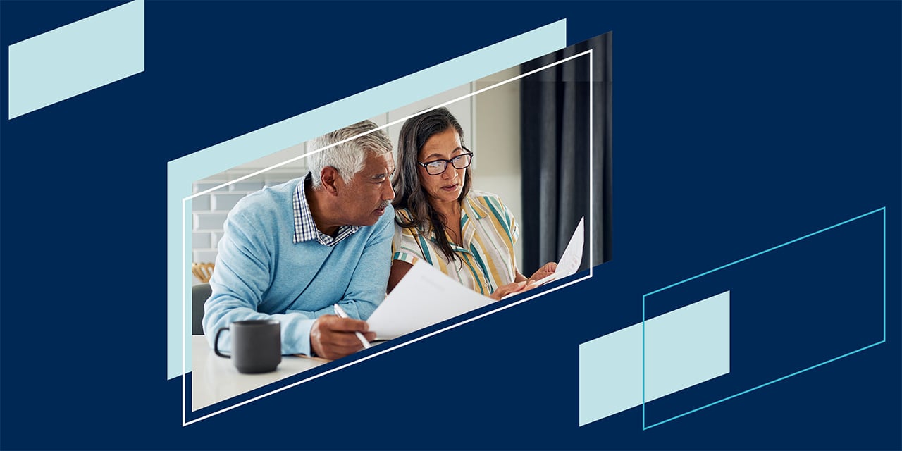 Blue parallelogram shapes framing a couple reviewing tax papers