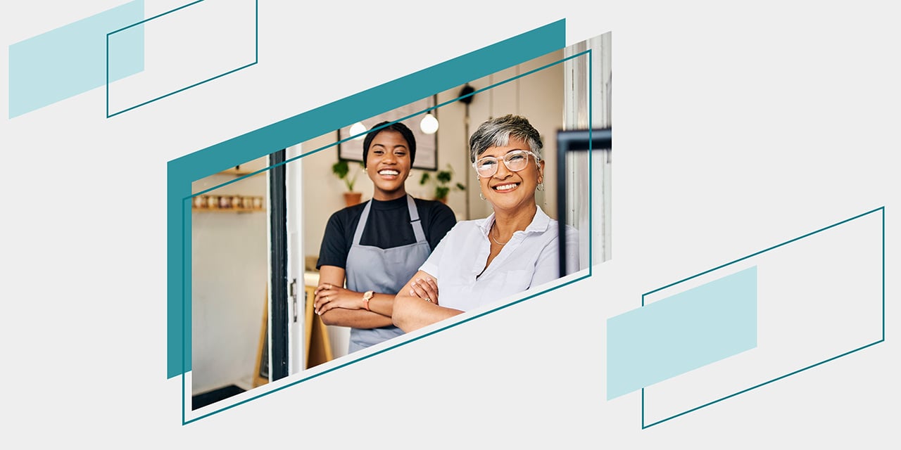 A young employee and middle aged manager standing in a coffee shop