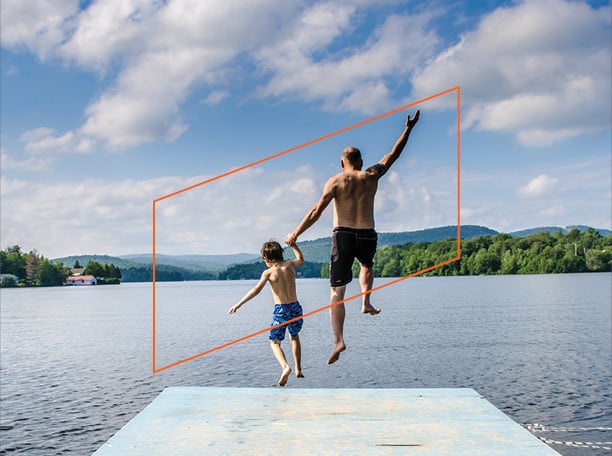 a grandparent and grandson holding hands while jumping off a pier into the lake