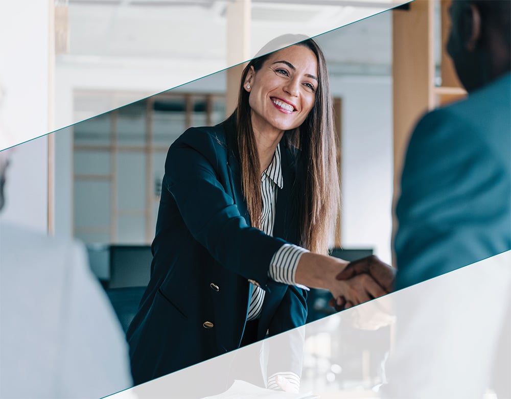A financial advisor shaking hands with their client