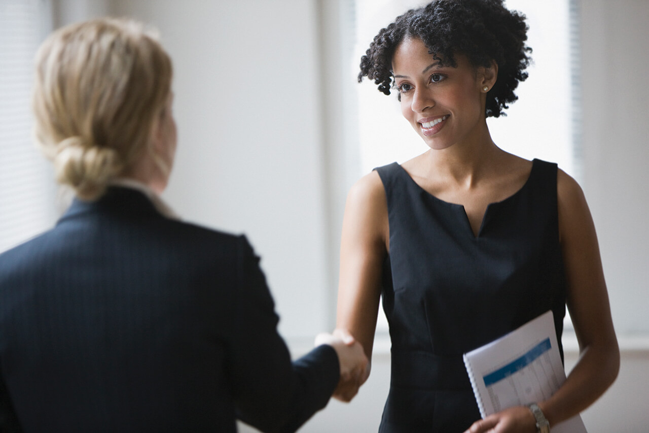 A retiree shaking hands with a financial advisor